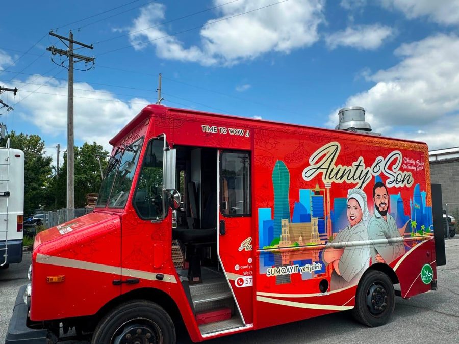 Aunty & Son red food truck seen from the driver side with the entry door open