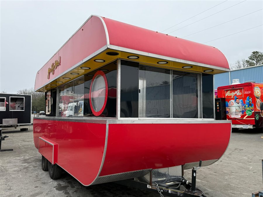 Red retro-style concession trailer with round porthole window and curved roofline